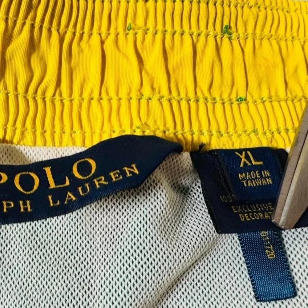 Polo Ralph Lauren green swim trunks with yellow trim.